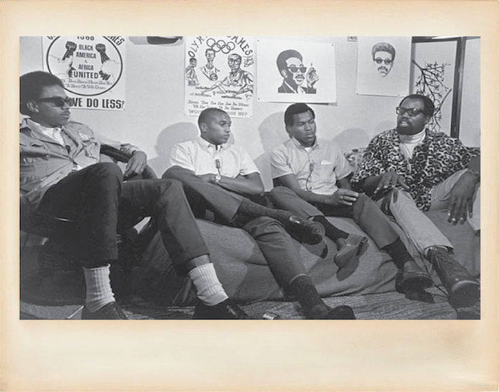 Four students, from left: Harry, Tommie, John, and Lee; sit together talking on a couch on the UC Berkeley campus, circa 1960's.